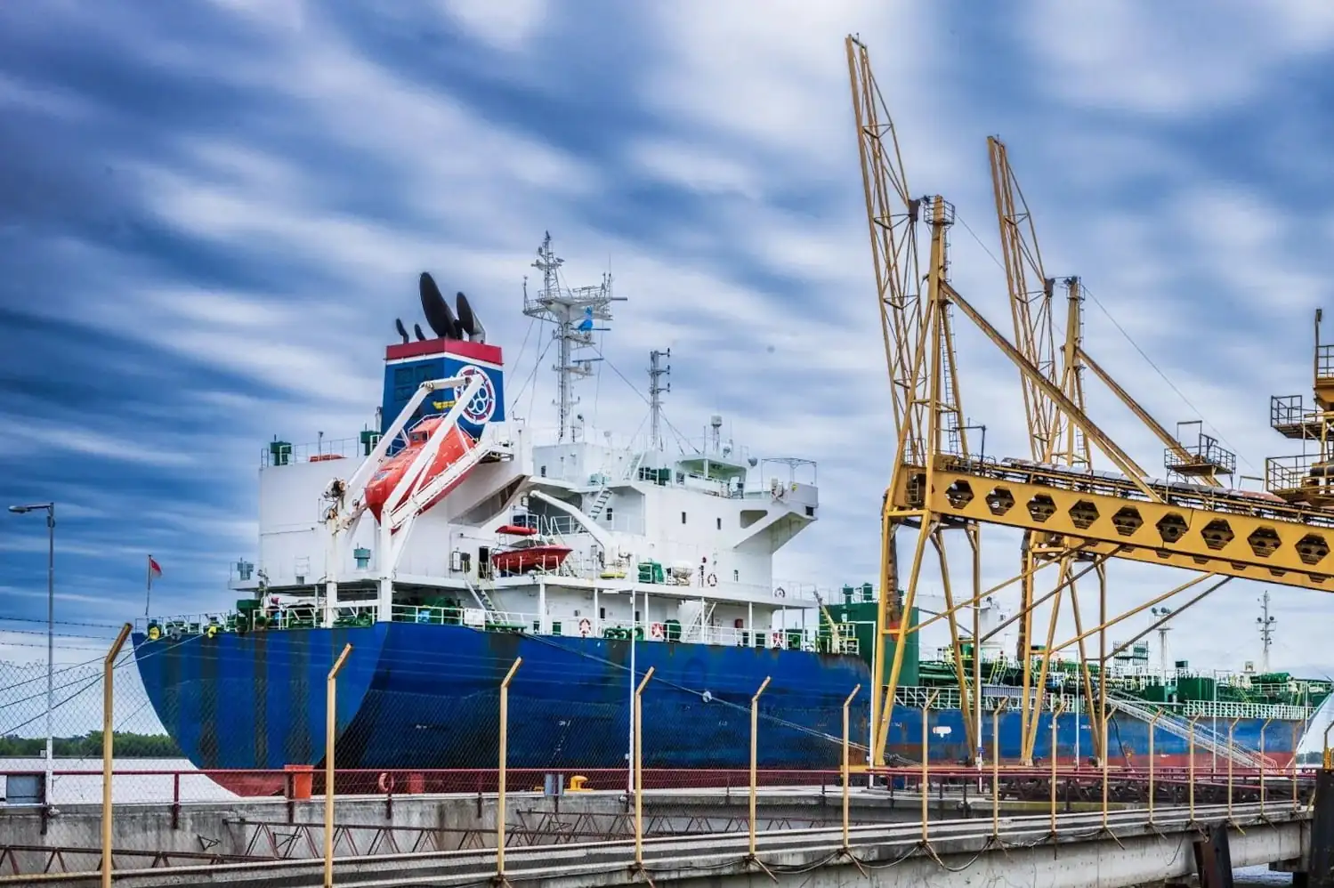 A ship beside a pier.